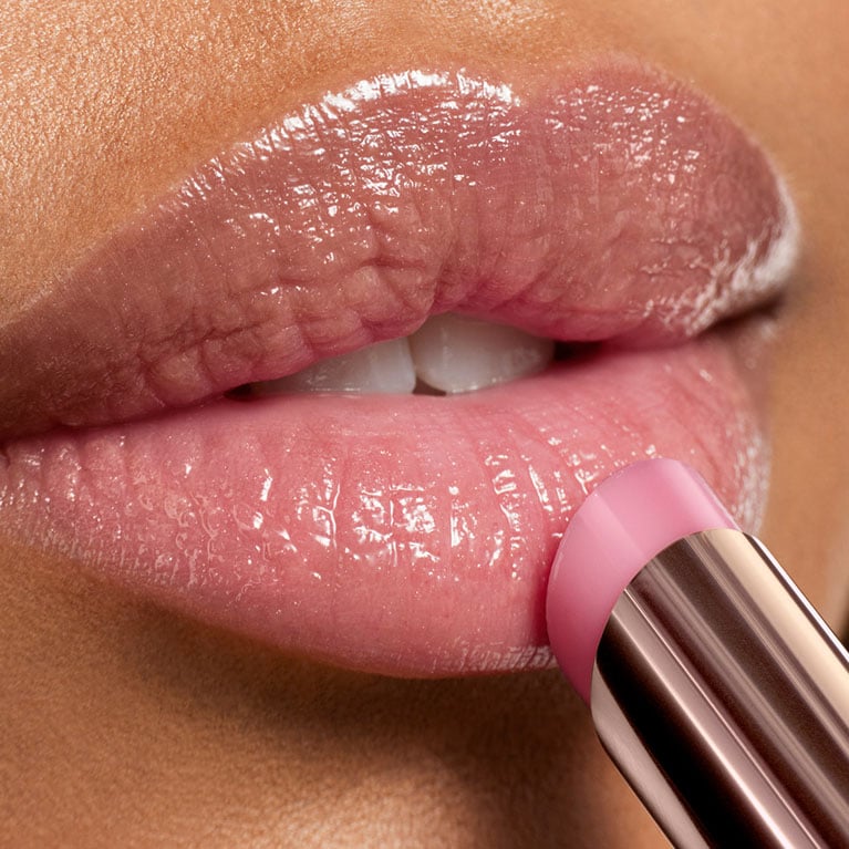 Model wearing Lip Idole Butterglow shiny lip balm for luminous and emphasized lips a signature of ethereal beauty makeup